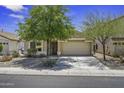 Charming single-story home with a well-manicured, low maintenance front yard and an attached two car garage at 40749 W Thornberry Ln, Maricopa, AZ 85138
