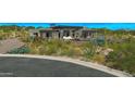 Desert landscaping surrounds this modern home with an inviting outdoor entertainment area at 41639 N 113Th Pl, Scottsdale, AZ 85262
