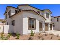 Side view of a two-story home featuring desert landscaping and a two-car garage at 5016 W Brown St, Glendale, AZ 85302