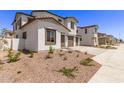 Street view of multiple two-story homes with desert landscaping and a two-car garage at 5016 W Brown St, Glendale, AZ 85302