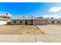 Charming single-story home with a well-maintained lawn and a classic design at 5129 W Windrose Dr, Glendale, AZ 85304