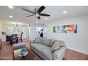 Comfortable living room featuring neutral tones, a ceiling fan, and adjacent dining area at 5550 N 12Th St # 2, Phoenix, AZ 85014