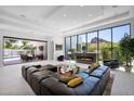 Bright living room features a fireplace, floor to ceiling windows, and access to backyard at 6321 N Camelback Manor Dr, Paradise Valley, AZ 85253