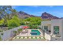 Inviting pool area with lounge chairs and mountain views for ultimate relaxation and entertainment at 6321 N Camelback Manor Dr, Paradise Valley, AZ 85253