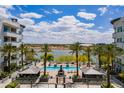 An overhead view of a stunning community pool surrounded by palm trees and lush landscaping at 945 E Playa Del Norte Dr # 3002, Tempe, AZ 85288