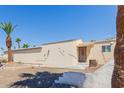 Charming single-story home featuring desert landscaping and mature palm trees for a tranquil outdoor setting at 10472 W Devonshire Ave, Phoenix, AZ 85037