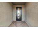 An inviting covered entrance with stylish pavers and a modern black metal door at 11623 W Marguerite Ave, Avondale, AZ 85323