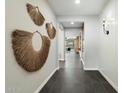 Bright hallway featuring elegant tile flooring and tasteful decorative wall hangings at 11623 W Marguerite Ave, Avondale, AZ 85323