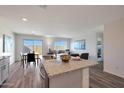 Open floor plan features kitchen with island, dining area, and living room with lots of light at 1179 N 13Th St, Coolidge, AZ 85128