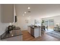 Bright open floor plan showcases a modern kitchen with an island, granite countertops, and stainless appliances at 1179 N 13Th St, Coolidge, AZ 85128