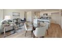 Open-concept living space featuring modern kitchen with island, dining area, and stylish furniture at 1179 N 13Th St, Coolidge, AZ 85128