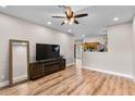 Bright living room offering hardwood floors, television, and open floor plan at 13171 W Redfield Rd, Surprise, AZ 85379