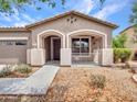 Beautiful front porch with an arched entrance and landscaped flower beds at 15216 W Westview Dr, Goodyear, AZ 85395