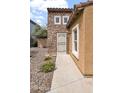 Close up of front door with decorative security door and stone siding at 17132 W Tara Ln, Surprise, AZ 85388