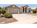 Charming single-story home showcasing a well-maintained lawn, tile roof, and a spacious three-car garage at 1932 S Arroyo Ln, Gilbert, AZ 85295