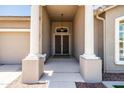 Covered front entrance featuring decorative pillars and a stylish front door with an overhead light fixture at 1932 S Arroyo Ln, Gilbert, AZ 85295