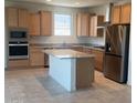 Well-appointed kitchen with granite counters, stainless steel appliances and center island at 19889 W Annika Dr, Litchfield Park, AZ 85340