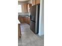 Spacious kitchen with a stainless steel refrigerator and light wood cabinets at 19889 W Annika Dr, Litchfield Park, AZ 85340