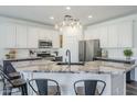 Well-equipped kitchen with stainless steel appliances, white cabinets, and a stylish backsplash at 2210 W Calle Del Sol --, Phoenix, AZ 85085