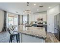 Spacious kitchen island featuring granite countertops, pendant lighting, and seating for four at 2210 W Calle Del Sol --, Phoenix, AZ 85085