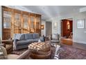 Inviting living room featuring an ornate wooden screen, comfortable seating, and a patterned rug at 2402 E Esplanade Ln # 1101, Phoenix, AZ 85016