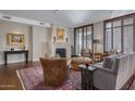 Warm living room with a fireplace, comfortable seating, and a patterned rug at 2402 E Esplanade Ln # 1101, Phoenix, AZ 85016