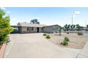 Cozy single-story home showcasing a low-maintenance desert landscaped yard with an attached carport and garage at 3237 S Albert Ave, Tempe, AZ 85282