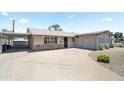 Single-story home boasts a covered parking space, low-maintenance desert landscape, and an attached one-car garage at 3237 S Albert Ave, Tempe, AZ 85282