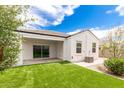 A backyard featuring artificial turf, covered patio, and privacy fencing at 3480 N 307Th Dr, Buckeye, AZ 85396