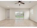 Bright, light-filled living room with tile flooring and sliding glass doors to the backyard at 3480 N 307Th Dr, Buckeye, AZ 85396