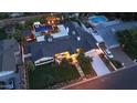 Aerial view featuring the home with a pool, fire pit area, covered patio and a spacious driveway at 3653 E Highland Ave, Phoenix, AZ 85018