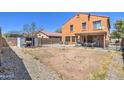 A large backyard with low-maintenance gravel and a covered patio, with block wall for privacy at 40437 W Robbins Dr, Maricopa, AZ 85138