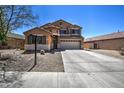 Charming two-story home with a manicured gravel yard and a spacious two car driveway at 40437 W Robbins Dr, Maricopa, AZ 85138