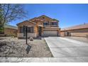 Two-story home featuring a spacious driveway, a two-car garage and neutral-colored exterior at 40437 W Robbins Dr, Maricopa, AZ 85138