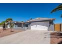 Attractive home featuring a large driveway, desert landscaping, and an attached two-car garage at 4506 W Golden Ln, Glendale, AZ 85302