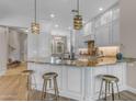 Bright kitchen featuring granite countertops, a kitchen island, and stylish pendant lighting at 4700 S Fulton Ranch Blvd # 62, Chandler, AZ 85248