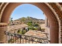 Charming balcony view showcasing the community's red tile roofs, gardens, and mountain scenery at 4949 E Lincoln Dr # 11, Paradise Valley, AZ 85253