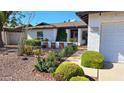 Charming entryway with decorative brick accents and mature landscaping, inviting curb appeal at 5002 W Christy Dr, Glendale, AZ 85304