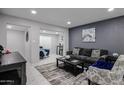 Cozy living room featuring tile floors, recessed lighting, and stylish, modern decor and furniture at 519 E El Camino Dr, Phoenix, AZ 85020