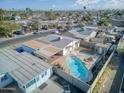 Aerial view of the property featuring a pool, covered patio, and neighborhood setting at 5407 W Cambridge Ave, Phoenix, AZ 85035