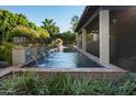 Inviting pool with decorative tile accents and fountain features, surrounded by lush greenery at 6019 N 62Nd Pl, Paradise Valley, AZ 85253