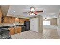 Open kitchen area with wood cabinets and modern black appliances flows into a large adjacent room at 6448 E Paso Nuevo Dr # 101, Cave Creek, AZ 85331