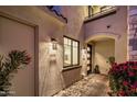 Inviting entrance with stone accents, modern lighting, and well-maintained landscaping at 6500 E Camelback Rd # 1010, Scottsdale, AZ 85251