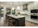 Bright kitchen boasting an island with counter seating, white cabinetry, and modern stainless appliances at 6500 E Camelback Rd # 1010, Scottsdale, AZ 85251