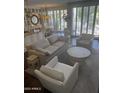 Bright living room with comfortable seating and floor-to-ceiling windows at 7222 E Gainey Ranch Rd # 106, Scottsdale, AZ 85258
