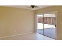 Bright, open living room featuring neutral walls and large sliding doors leading to the backyard at 7506 W Devonshire Ave, Phoenix, AZ 85033