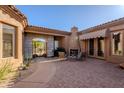 Comfortable seating in a cozy courtyard with fireplace at 8392 E Eagle Feather Rd, Scottsdale, AZ 85266