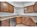 An ample kitchen offers plentiful counter space, a stainless steel dishwasher, and natural wood cabinetry at 8787 E Mountain View Rd # 1087, Scottsdale, AZ 85258