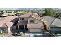 Beautiful aerial view of a two-story home with a tile roof, showcasing its prime location in a residential neighborhood at 10031 W Hess St, Tolleson, AZ 85353