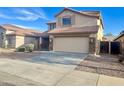 Beautiful home with desert landscaping, tile roof, and a spacious driveway at 10031 W Hess St, Tolleson, AZ 85353